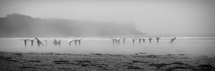 Surfers in the mist