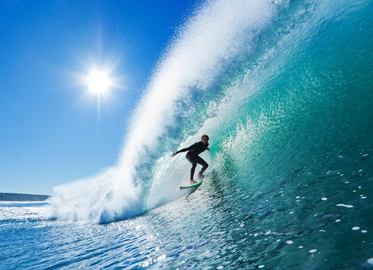 Surfer on blue ocean wave