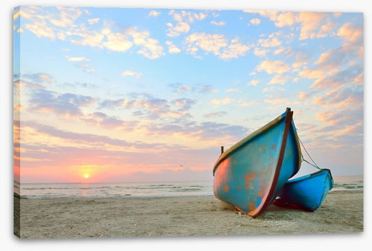 Blue boats at sunrise